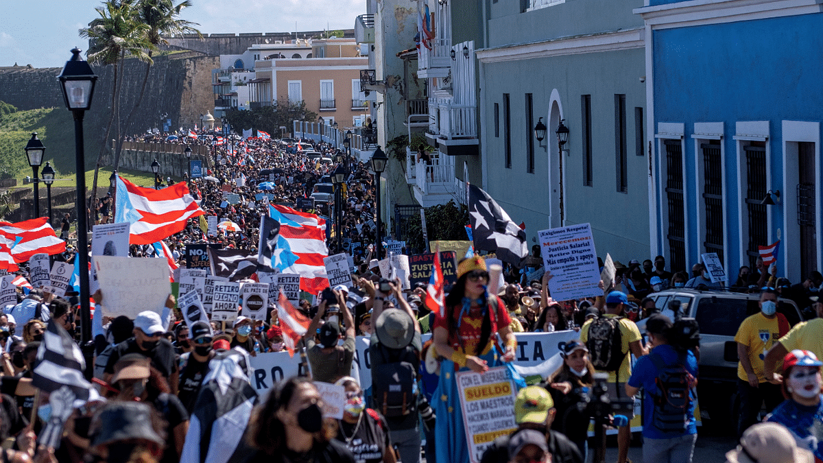 People march through the streets of Old San Juan during a protest of teachers demanding salary increase and better working conditions, in San Juan, Puerto Rico. Credit: Reuters Photo