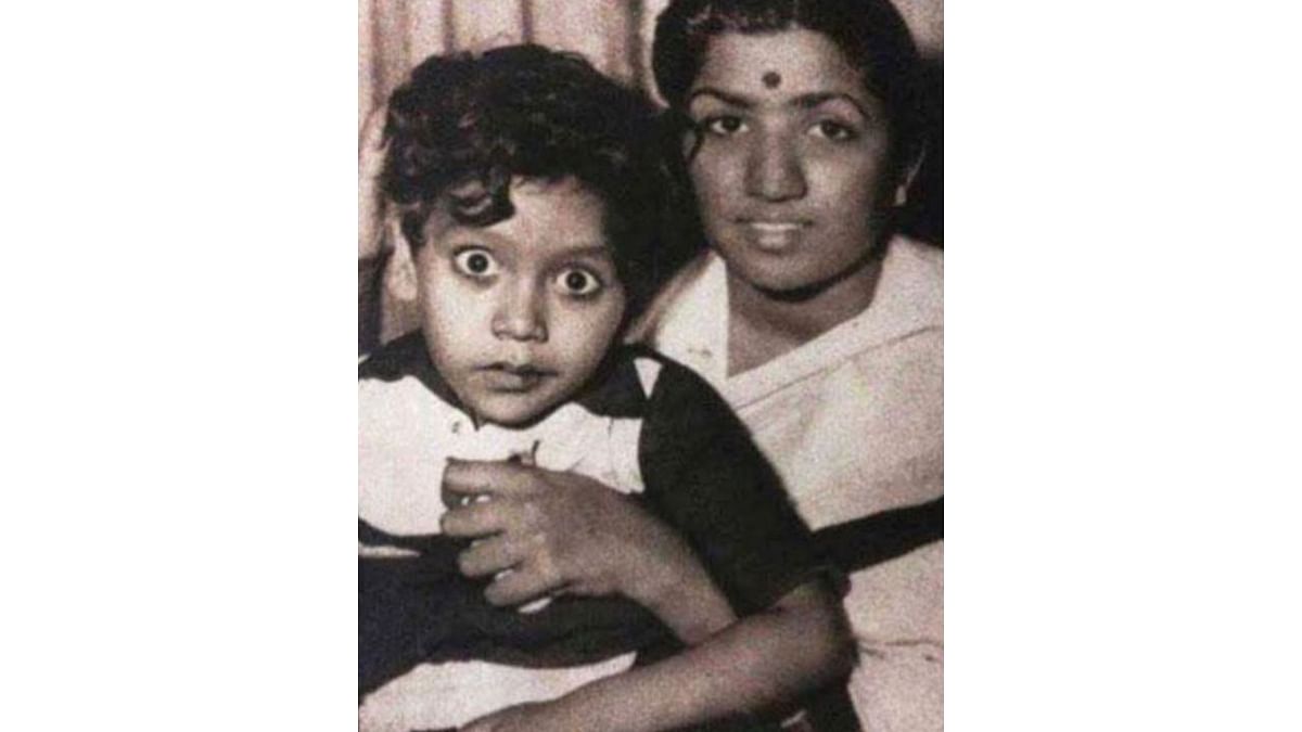 An adorable picture of Bappi Lahiri sitting on the lap of singer Lata Mangeshkar. Credit: Instagram/bappilahiri_official_