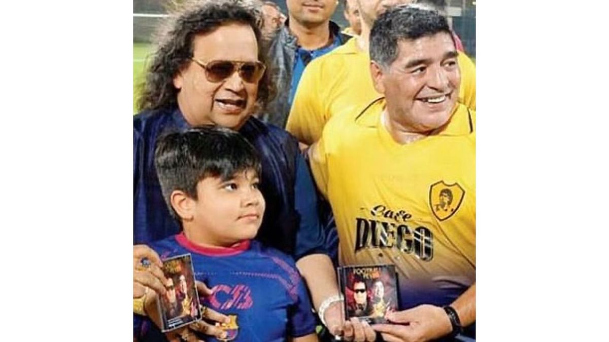 Bappi Lahiri was an adrent fan of soccer legend Maradona. He even gifted him a song called Football Fever, which he specially composed in 2016. In this photo, Bappi Lahiri is seen gifting the Football Fever song to Maradona. Credit: Instagram/bappilahiri_official_