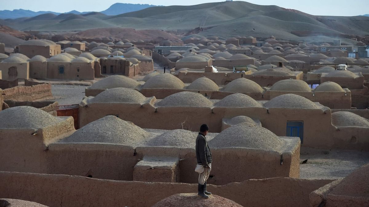 A youth stands on the rooftop of his mud house at Tabaqsar village of Adraskan district, Herat province. Credit: AFP Photo