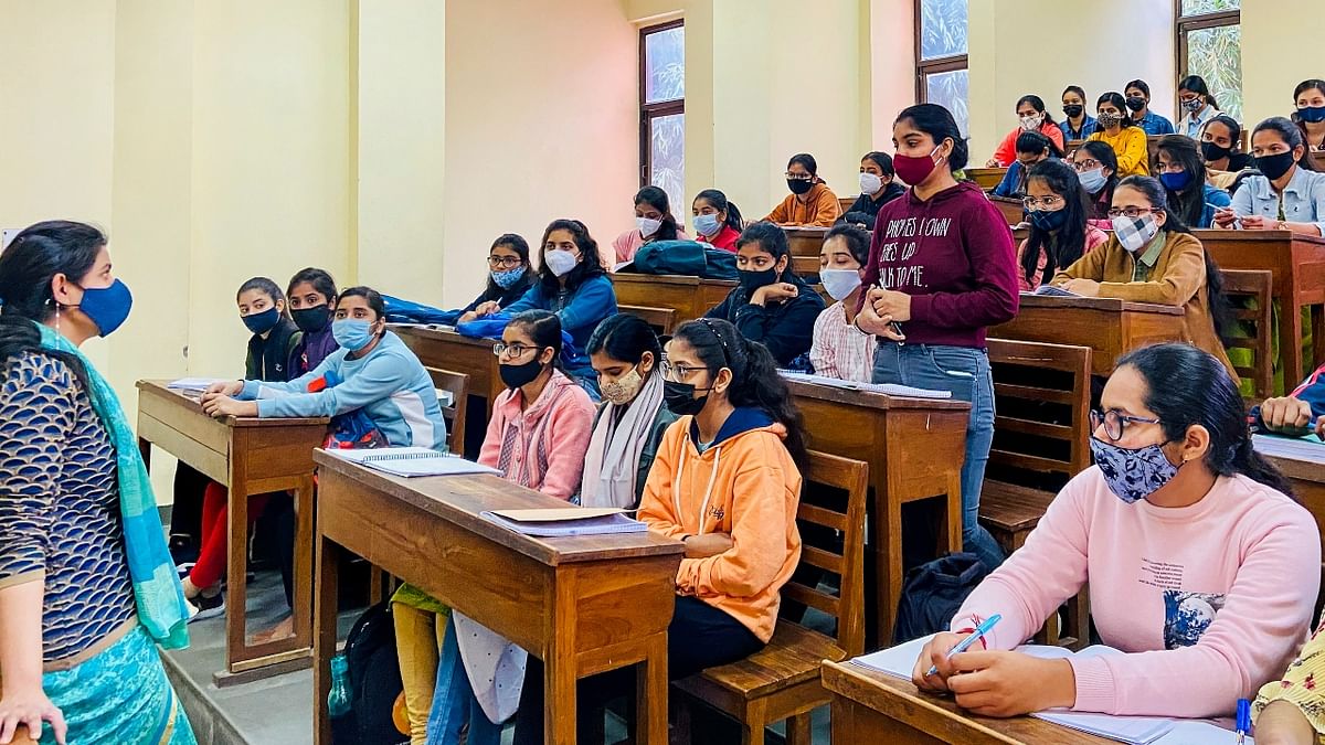 Classrooms are abuzz with students wearing masks. Credit: PTI Photo