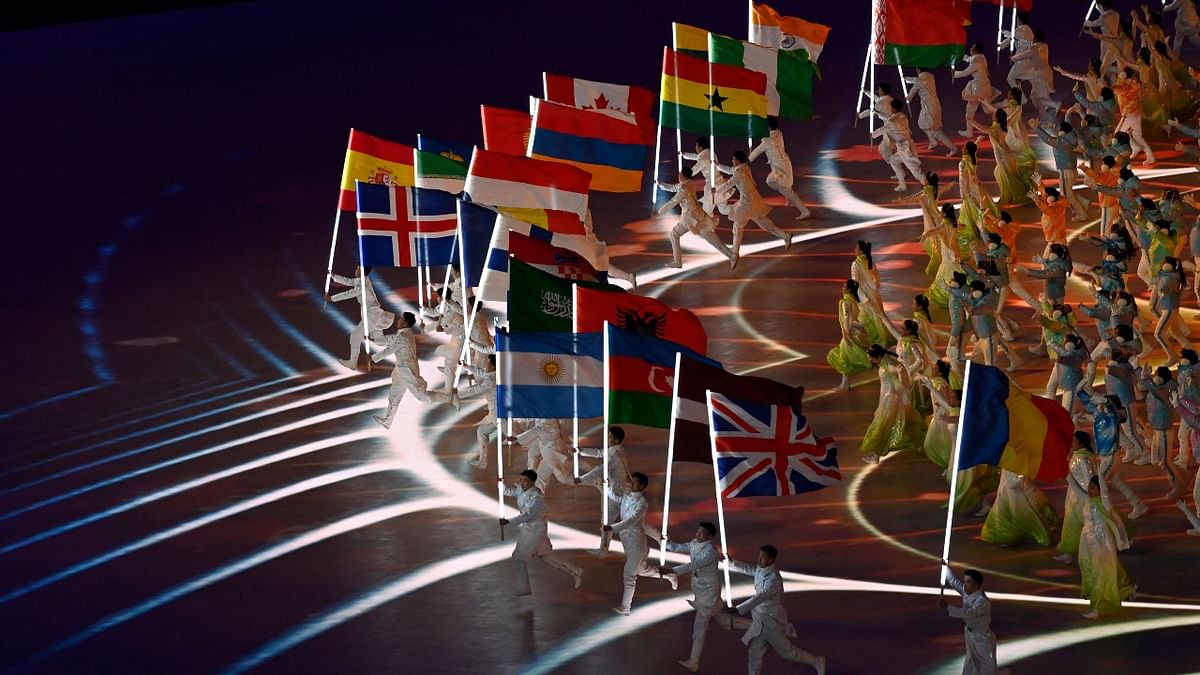 Performers wave national flags during the closing ceremony of the Beijing 2022 Winter Olympic Games at the National Stadium in Beijing. Credit: AFP Photo