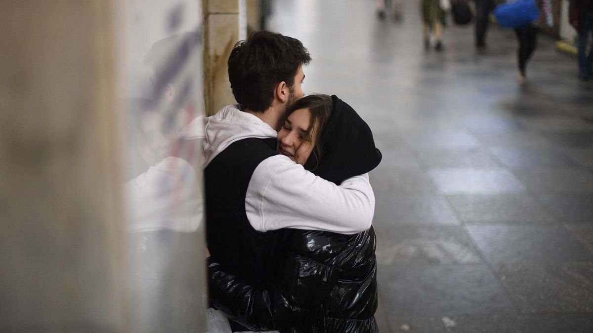 A couple hugs as they console each other after Russia invades Ukraine, in Kyiv. Credit: AFP Photo