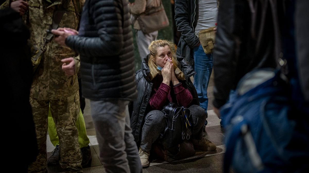 A woman gets emotional as she waits for a train trying to leave Kyiv, Ukraine. Credit: AP Photo