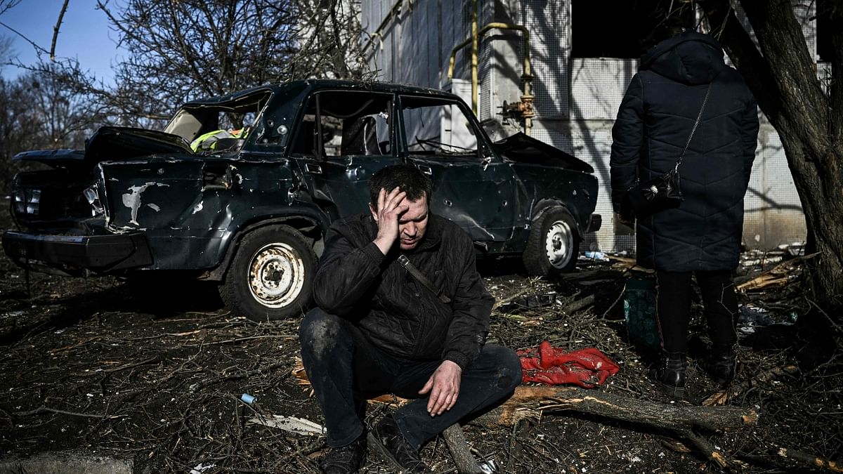 A man looks dejected as he sits outside his destroyed building in Chuguiv, Ukraine. Credit: AFP Photo