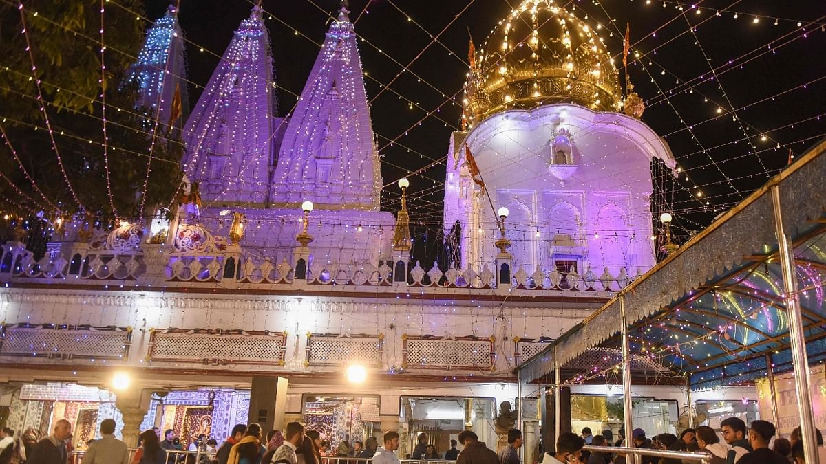 Devotees arrive in the wee hours of the morning to offer their prayers to Lord Shiva at the illuminated Shivala Bhaiyaan Mandir in Amritsar. Credit: AFP Photo