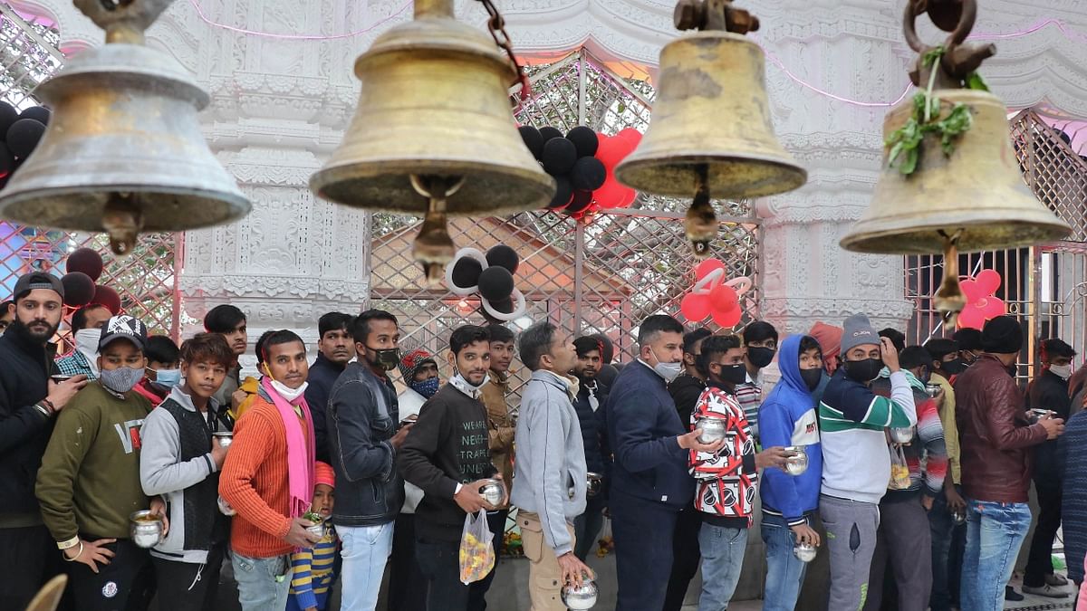 Devotees wait to offer prayers to Lord Shiva on the occasion of Maha Shivratri, at Aap Shambu Temple, in Jammu. Credit: PTI Photo