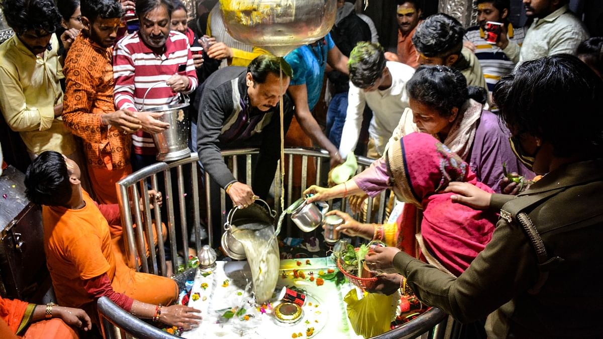 Devotees perform 'abhishek' of Lord Shiva at Anandeshwar temple on the occasion of Maha Shivratri, in Kanpur. Credit: PTI Photo