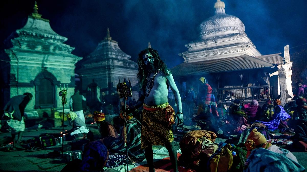 A sadhu stands near the lord Shiva temple at the Pashupatinath temple in Kathmandu. Credit: AFP Photo