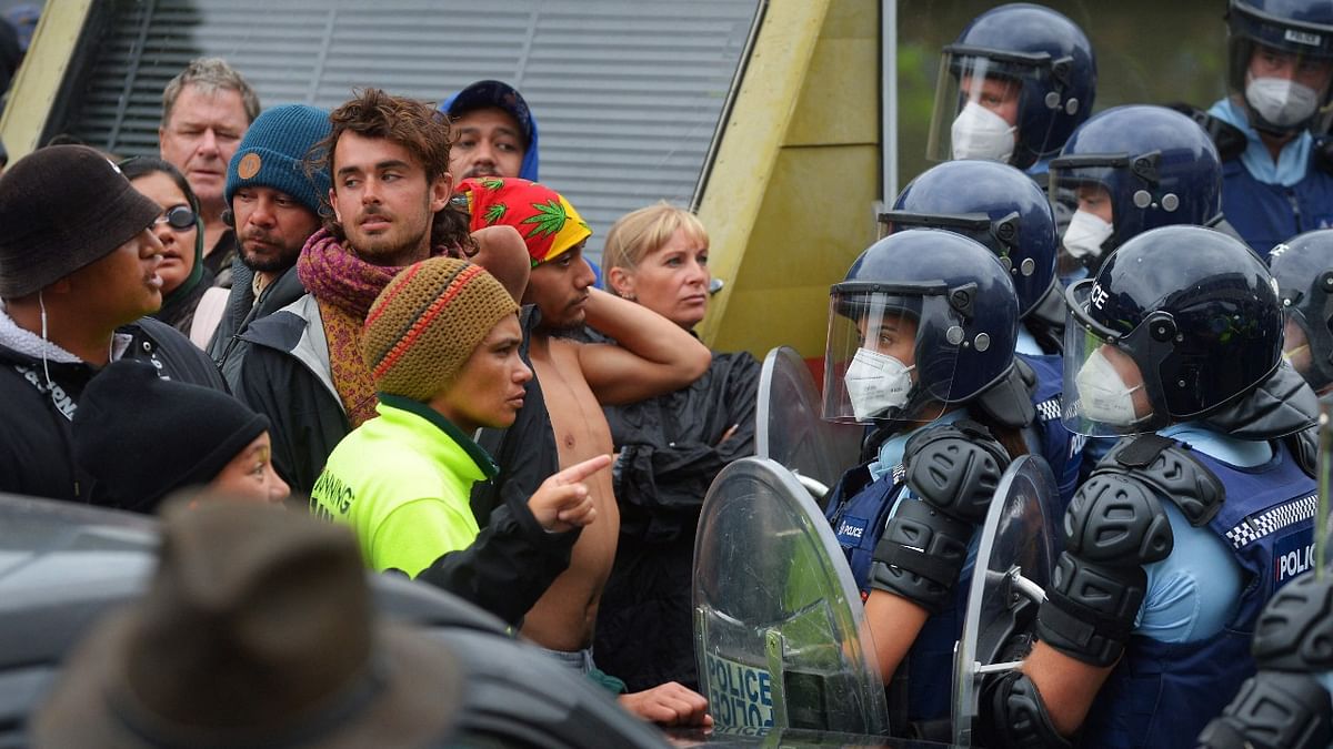 Riot police stand guard as protesters against Covid-19 vaccine manadates and restrictions gather near parliament grounds in Wellington. Credit: AFP Photo