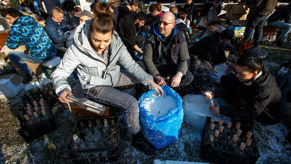 Local residents prepare Molotov cocktails to defend the city, after Russia launched a massive military operation against Ukraine, in Uzhhorod, Ukraine. Credit: Reuters Photo