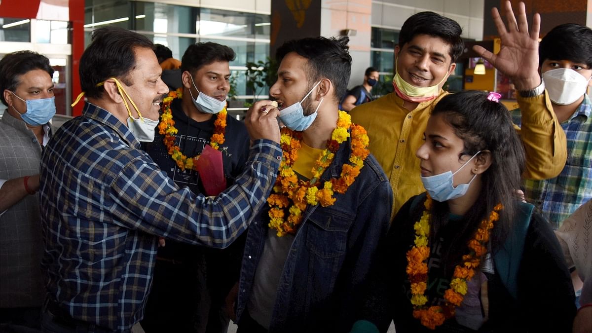 Staff at airports witnessed an array of emotions as parents gave their children a grand welcome with flowers, cards and warm hugs upon their arrival. Credit: PTI Photo