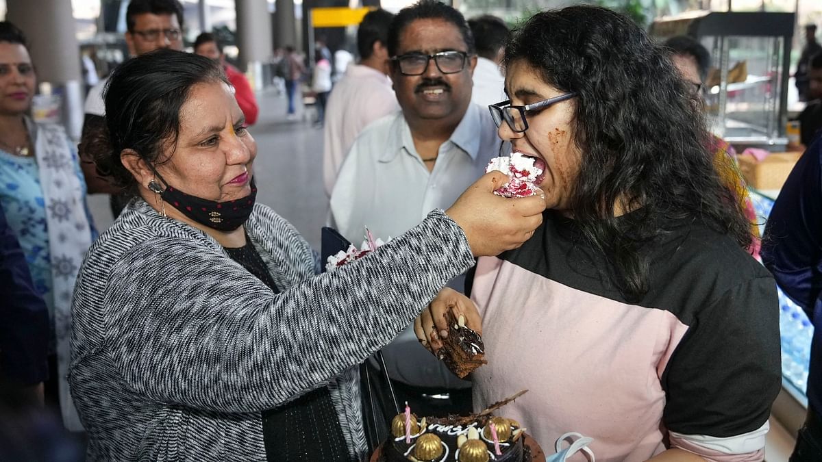 An Indian student celebrates her birthday with relatives upon her arrival from crisis-hit Ukraine at the airport in Mumbai. Credit: PTI Photo