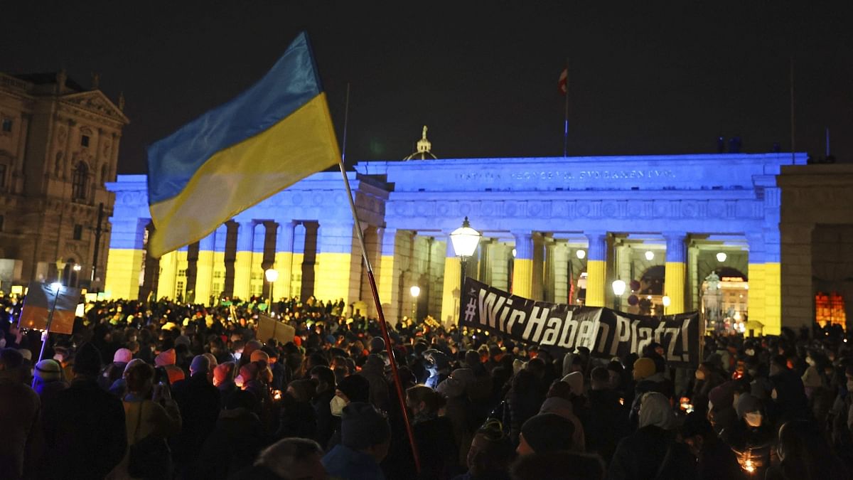 The Heldenplatz in Vienna is lit up with the colours of the Ukrainian flag during a demonstration where people light candles to form a sea of lights for peace in Ukraine. Credit: AFP Photo