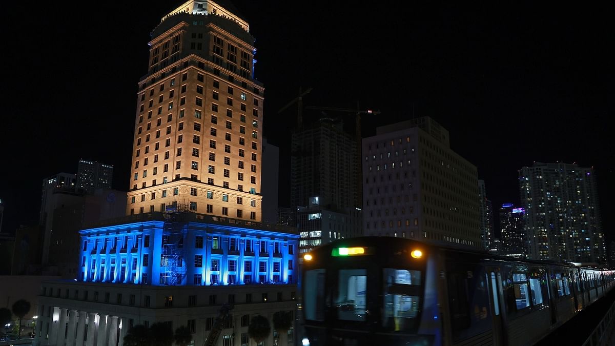 The Miami-Dade courthouse is lit in blue and yellow lights in a show of solidarity with Ukraine. Credit: AFP Photo