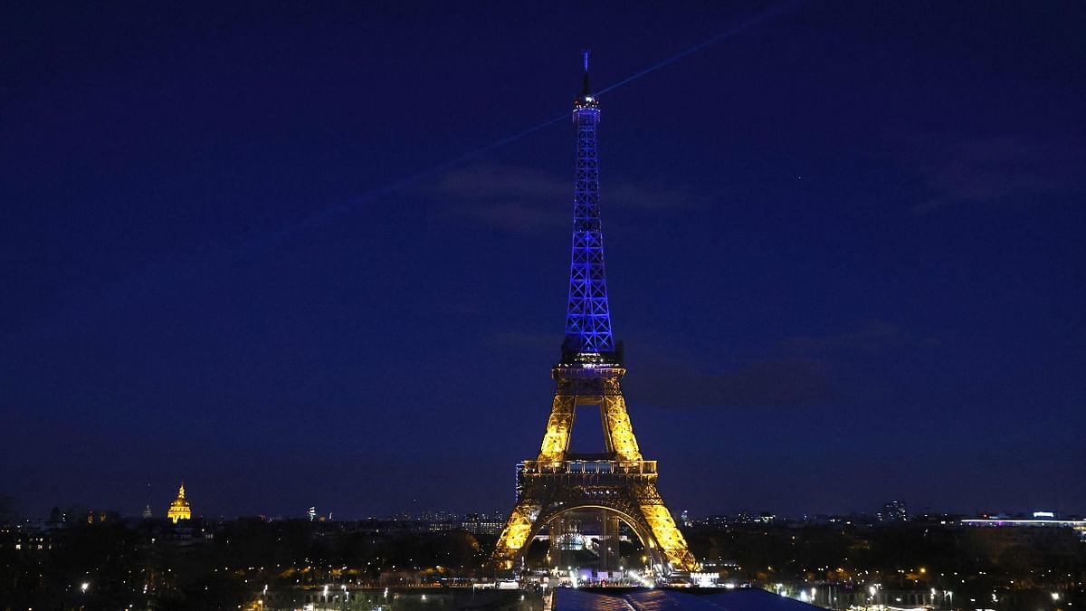 Eiffel Tower lit up in blue and yellow, the colours of the Ukrainian flag o show solidarity with their people. Credit: AFP Photo