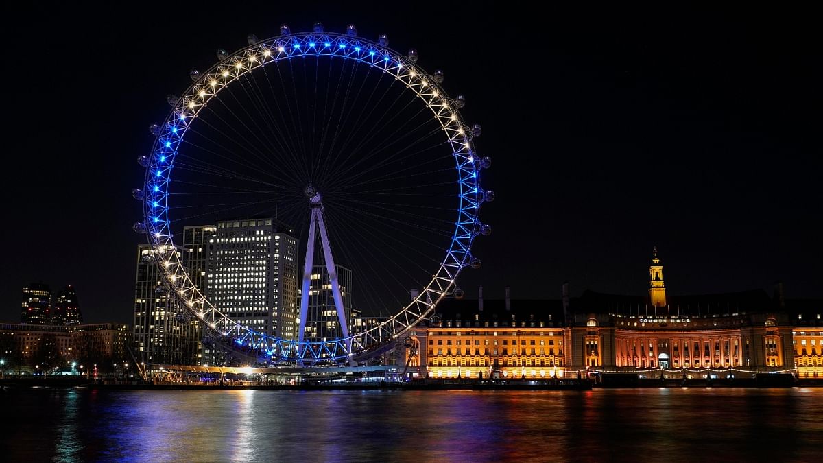 UK's one of the famous tourist attractions, The London Eye, also lit up in the colours of the Ukraine flag, in London. Credit: AP Photo