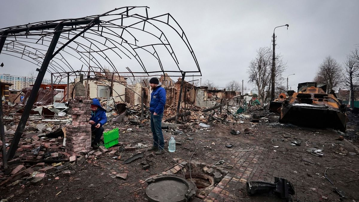eople look at the destroyed building in the town of Bucha, close to the capital Kyiv, Ukraine. Credit: AP Photo