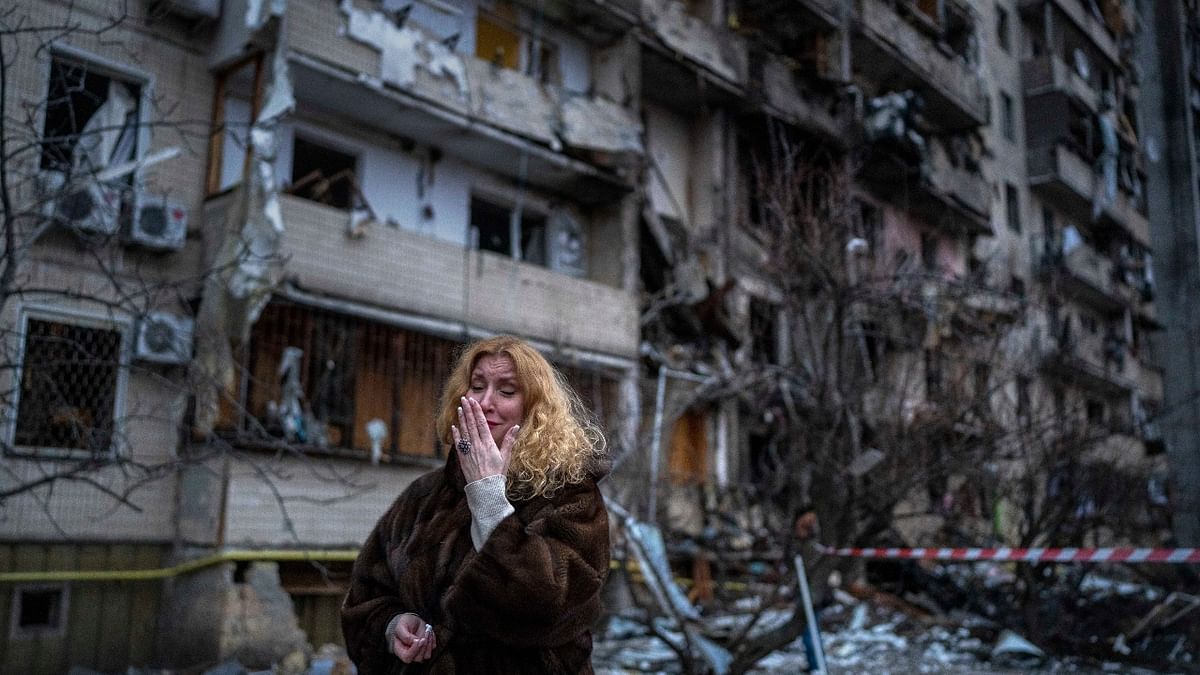 A woman reacts next to her damaged house following a rocket attack on the city of Kyiv, Ukraine. Credit: AP Photo