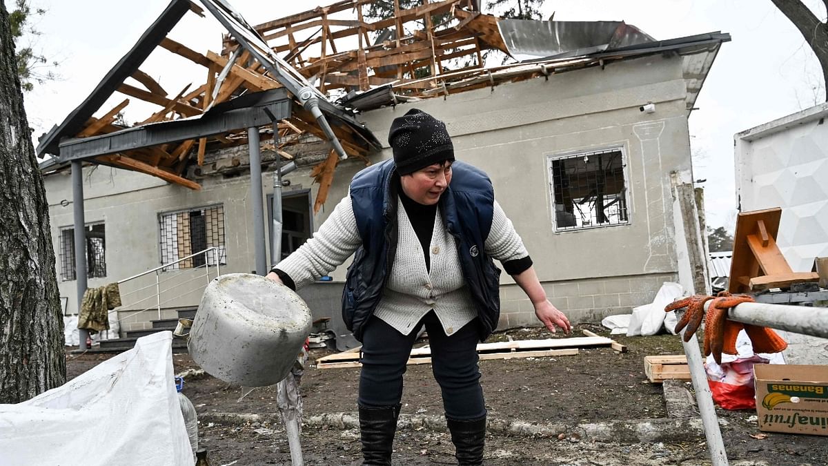 A woman inspects the front building which was destroyed by recent shelling on a check-point in the city of Brovary outside Kyiv in Ukraine. Credit: AFP Photo