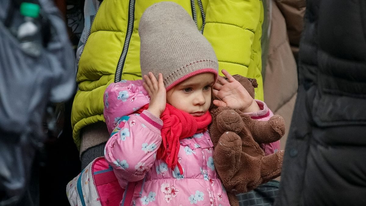 A girl reacts during air raid signal as people wait to board an evacuation train from Kyiv to Lviv following Russia's invasion of Ukraine, in Kyiv. Credit: Reuters Photo