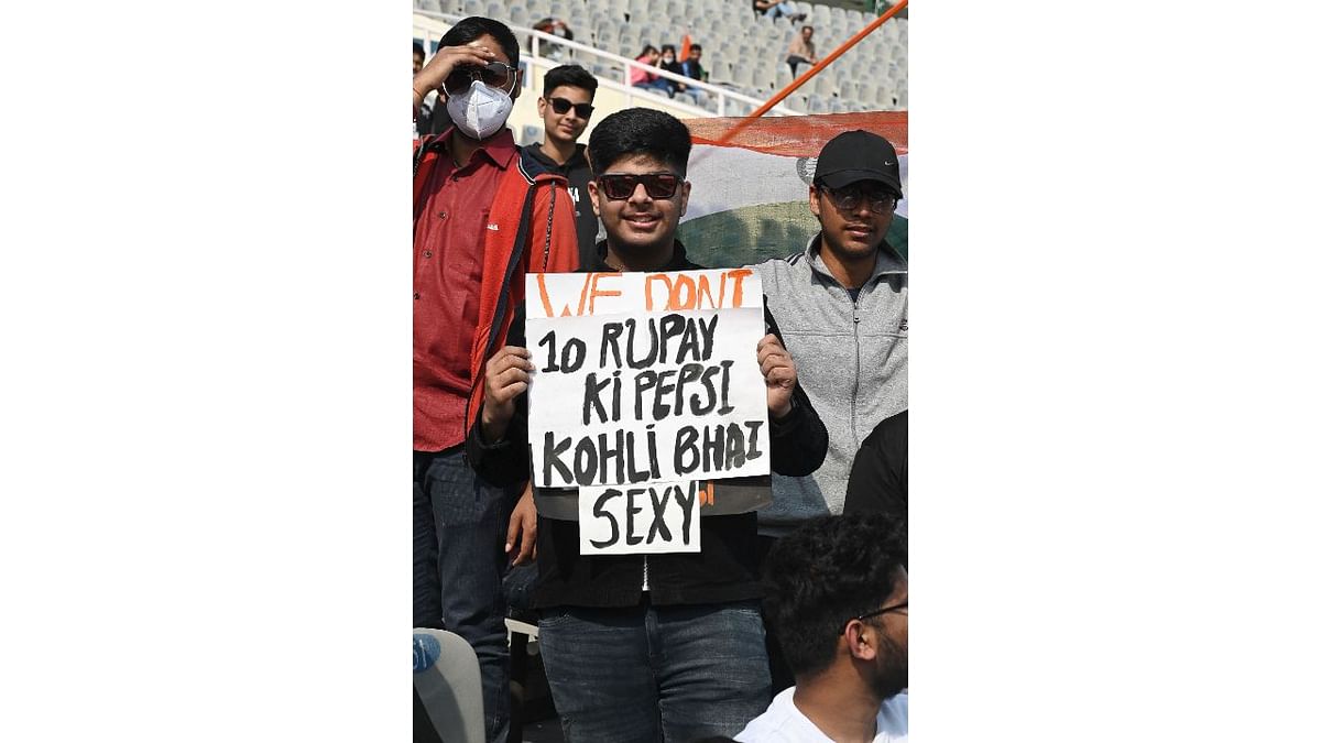 Fans of Virat Kohli cheer for the team during the first Test match between India and Sri Lanka at the Punjab Cricket Association Stadium in Mohali. Credit: AFP Photo