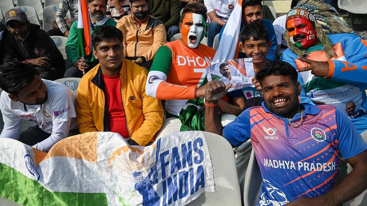 Fans of India's Virat Kohli cheer during the first day of the first Test cricket match between India and Sri Lanka at the Punjab Cricket Association Stadium in Mohali. Credit: AFP Photo