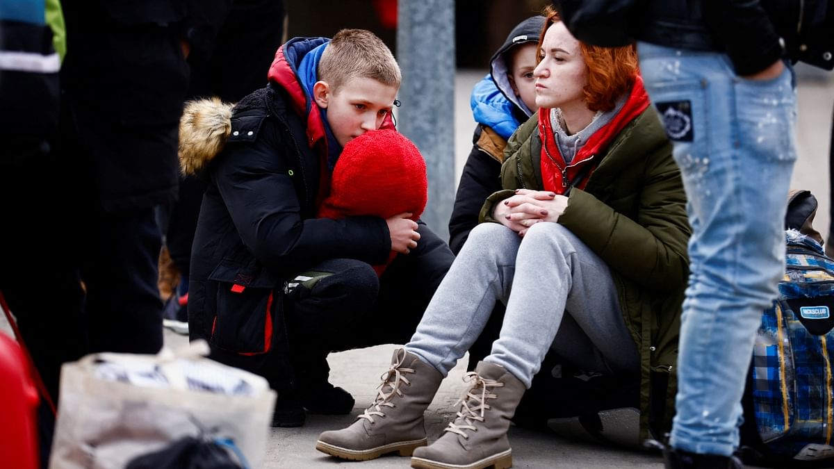 People wait on a platform at the train station after fleeing the Russian invasion of Ukraine, in Przemysl, Poland. Credit: Reuters Photo