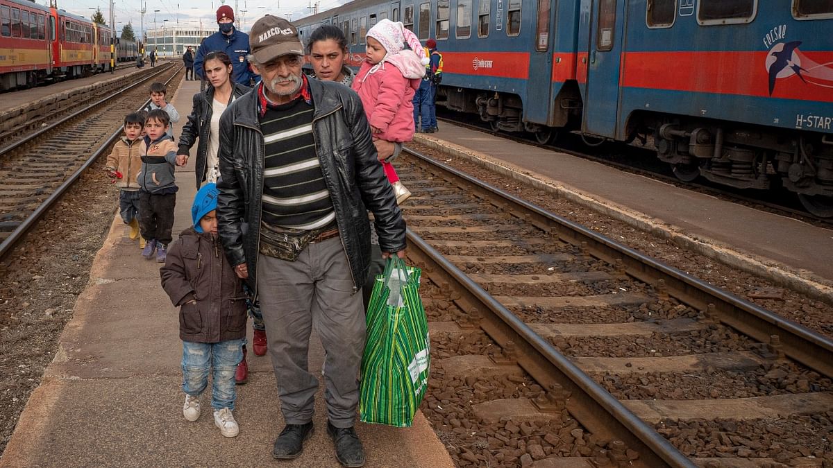 Refugees fleeing the war from neighboring Ukraine walk on a platform after disembarking from a train in Zahony, Hungary. Credit: AP Photo