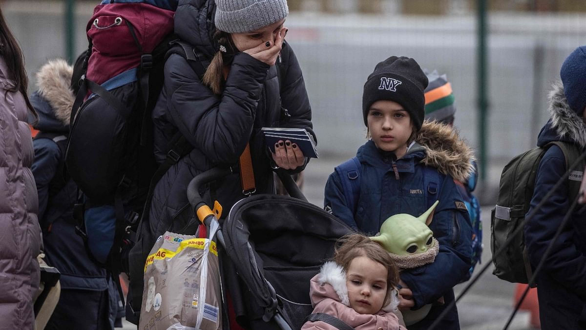 Refugees from Ukraine are pictured after crossing the Ukrainian-Polish border in Korczowa. Credit: AFP Photo