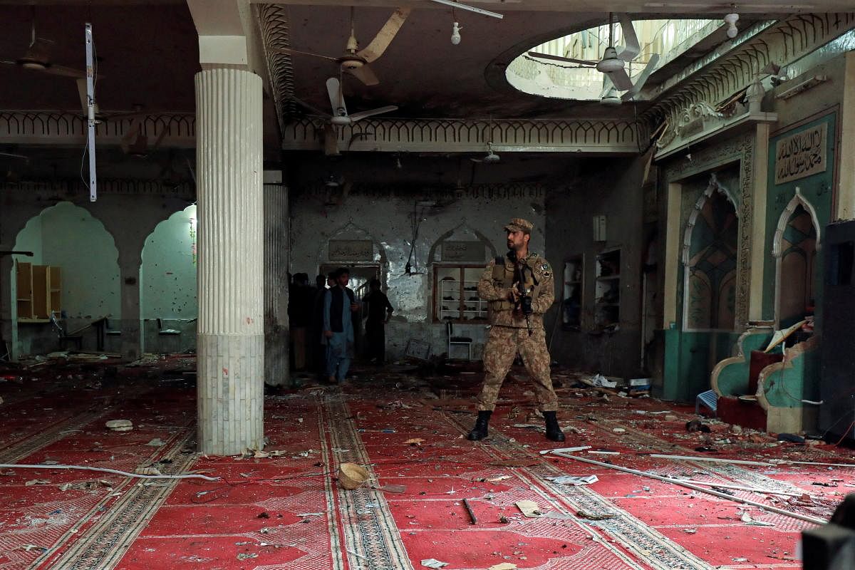 An army soldier stands amid the damages at the prayer hall after a bomb blast inside a mosque during Friday prayers in Peshawar, Pakistan. Credit: Reuters Photo