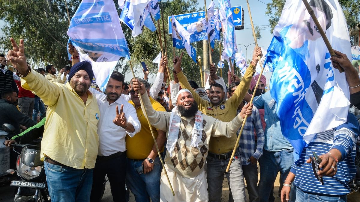 Aam Aadmi Party (AAP) supporters celebrate their party's lead during counting day of Punjab Assembly elections, in Jalandhar. Credit: PTI Photo