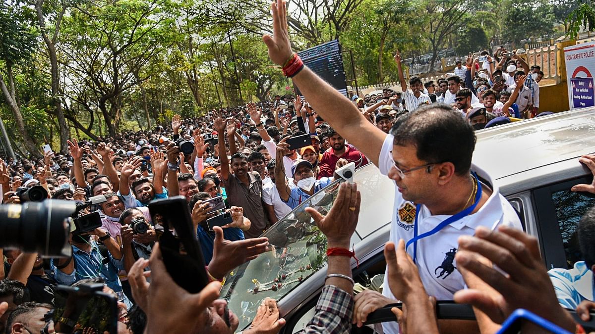 Goa Health Minister Vishwajeet Rane flashes victory signs as he greets the party workers during the counting day of Goa elections, at a counting centre in Panaji. Credit: PTI Photo