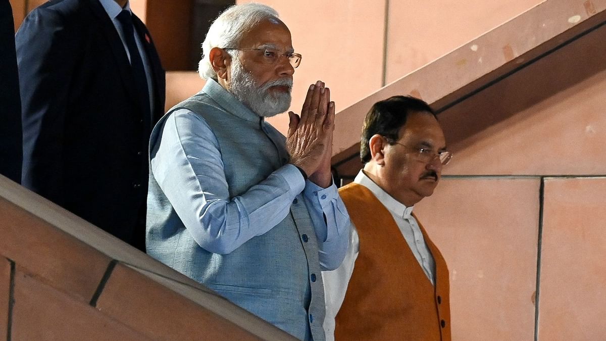 Prime Minister Narendra Modi greets the supporters at the BJP headquarters during a ceremony to celebrate the party's win in four states assembly elections, in New Delhi. Credit: AFP Photo