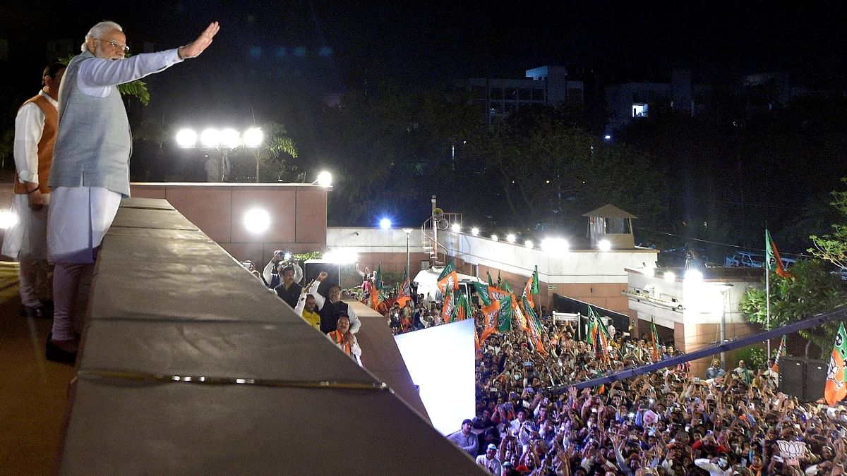 Prime Minister Narendra Modi greets the gathered BJP supporters during celebrations at the BJP Headquarters in New Delhi. Credit: PTI Photo