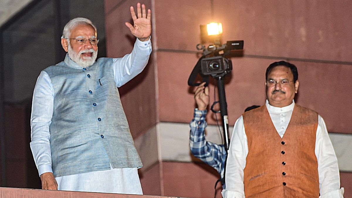 PM Narendra Modi waves at the supporters as BJP President JP Nadda looks on during celebrations at the BJP Headquarters in New Delhi. Credit: PTI Photo