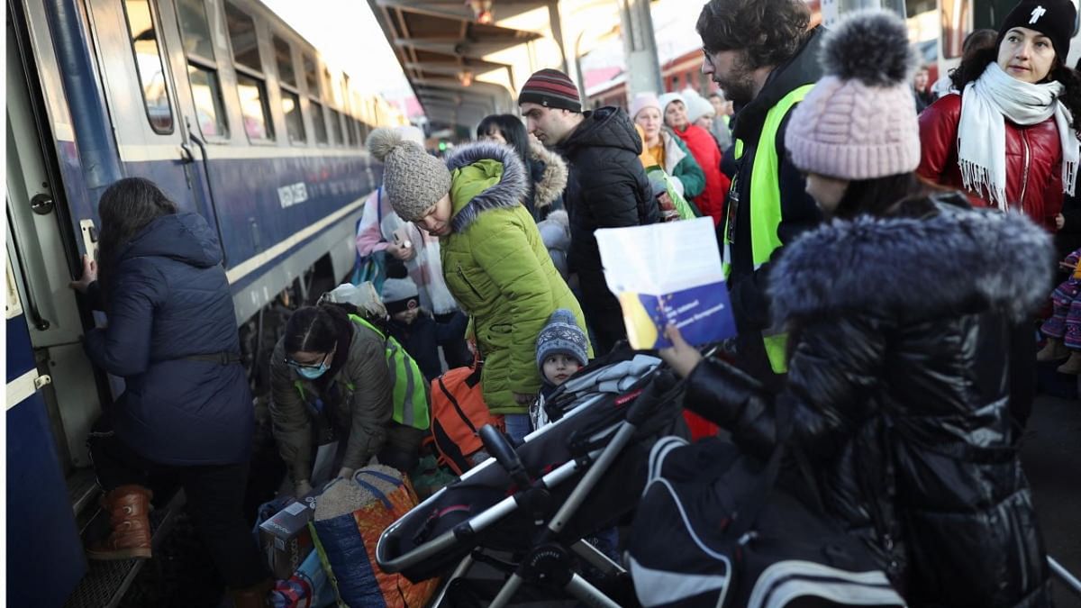 Ukrainian refugees, fleeing their country following the Russian invasion, board a train to travel to Brussels, Belgium, after arriving from the border with Ukraine, in Bucharest. Credit: Reuters photo