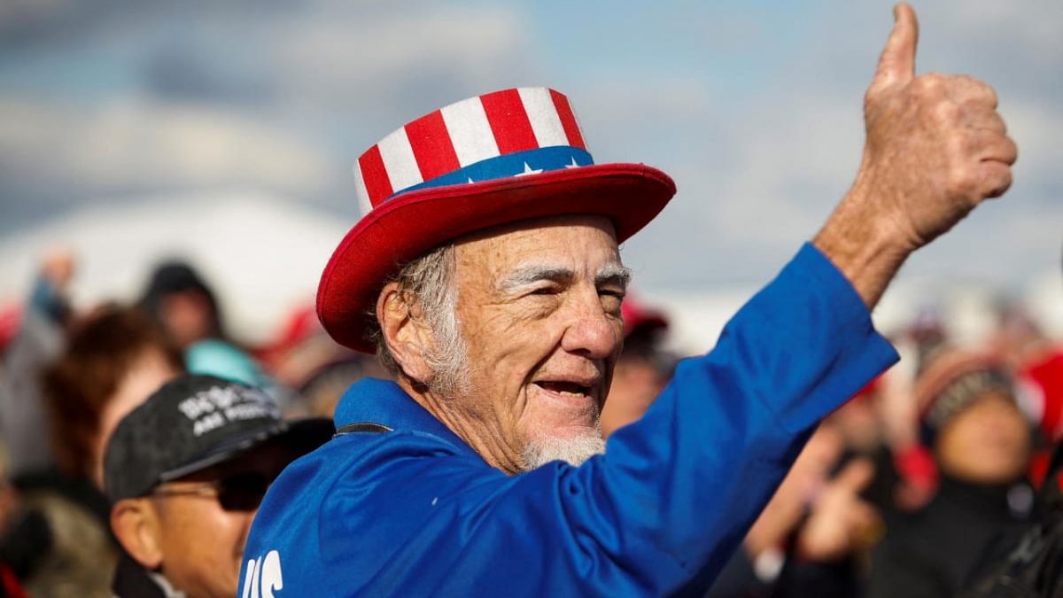 A supporter of former US President Donald Trump gives a thumbs-up at a rally at Florence Regional Airport in Florence, South Carolina. Credit: Reuters photo