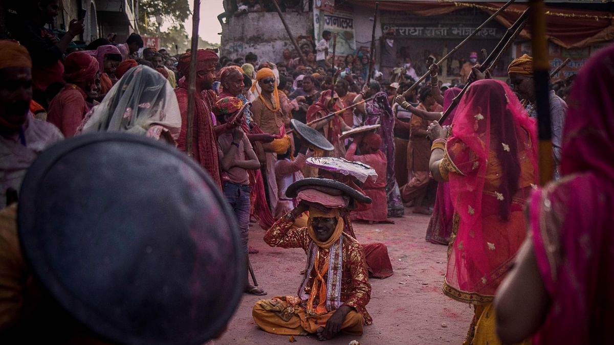Singing traditional songs like 'Faag Khelan Barsane Aye Hain Natwar Nand Kishor' (Krishna has come to Barsana to play Holi sport), men protected themselves from sticks by using improvised leather shields. Credit: AFP Photo