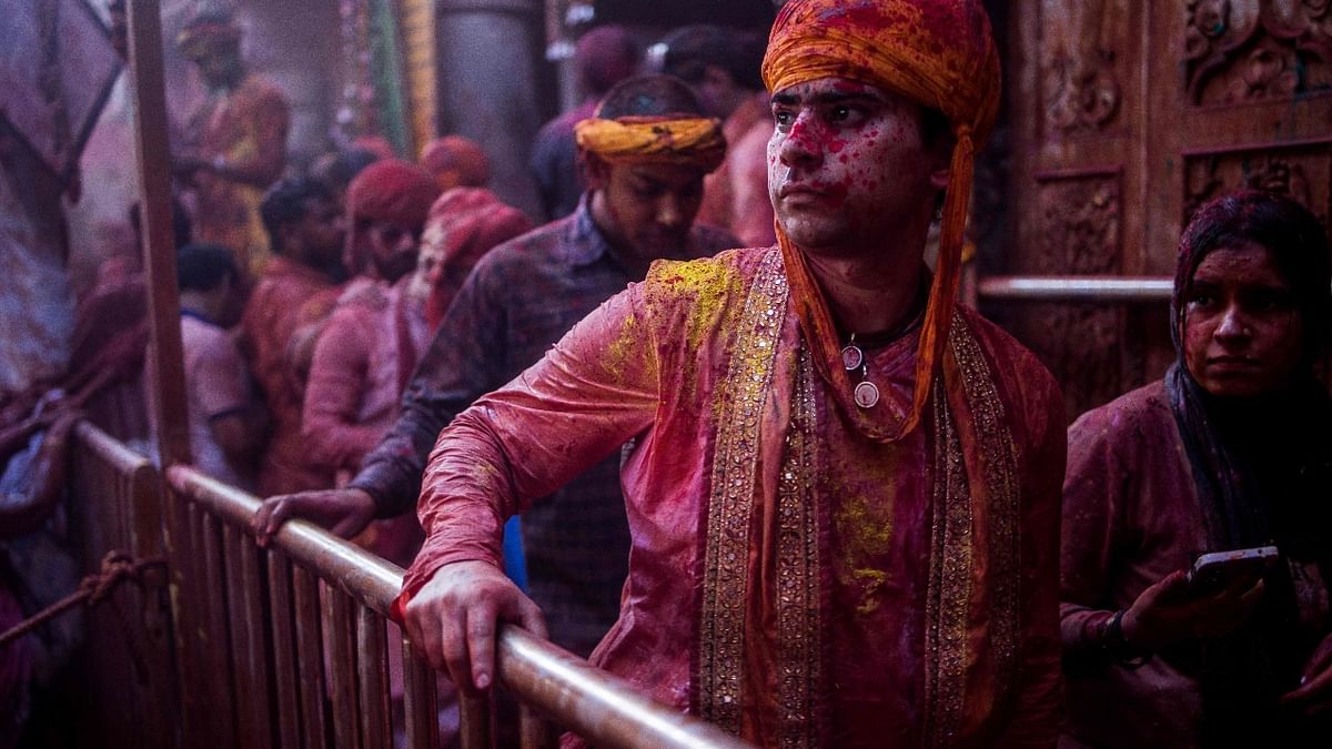A reveller exits after offering prayers at the Radha Rani temple during the Lathmar Holi celebrations in Barsana village, Uttar Pradesh. Credit: AFP Photo