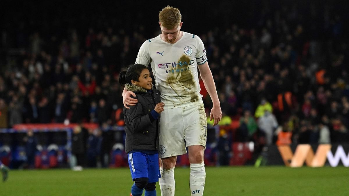 Manchester City's Belgian midfielder Kevin De Bruyne talks to a young pitch invader before giving the young fan his shirt, after the English Premier League match against Crystal Palace at Selhurst Park. Credit: AFP Photo