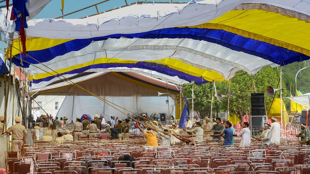 Workers giving finishing touches at the venue where AAP's Punjab CM-designate Bhagwant Mann will take oath as Punjab Chief Minister at Khatkar Kalan, near Jalandhar, in Punjab. Credit: PTI Photo