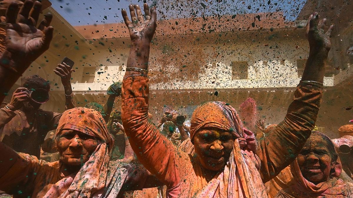 Holi celebrations started in Vrindavan, where elderly women daubed in splotches of colours and danced the day away together. Credit: AFP Photo
