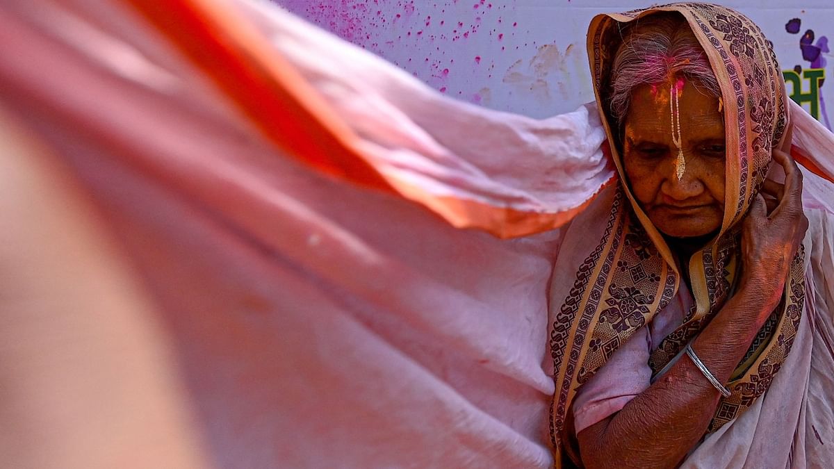 A widow gets clicked during the Holi celebrations in Vrindavan. Credit: AFP Photo