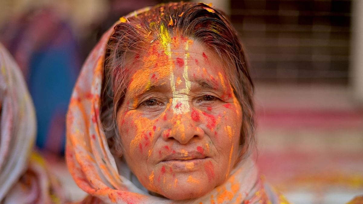 A widow poses as she participates in Holi celebrations, in Vrindavan. Credit: AFP Photo