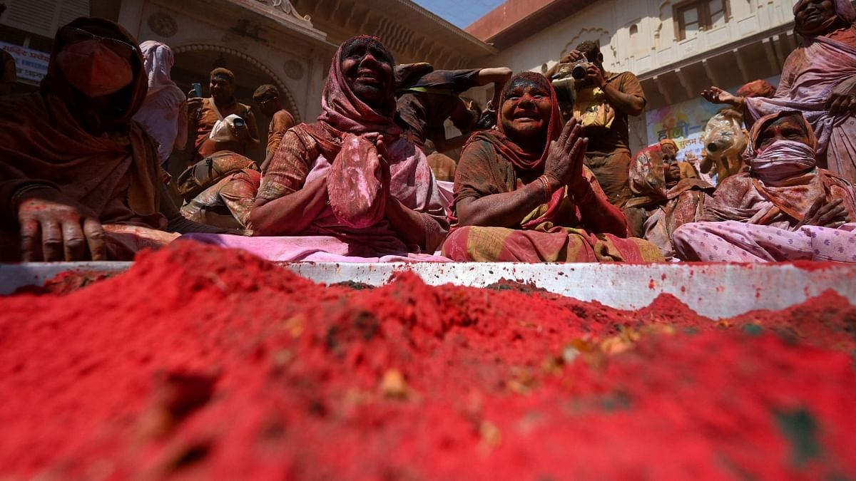 The spring festival saw hundreds of widows hurling coloured powder and water on each other. Credit: AFP Photo
