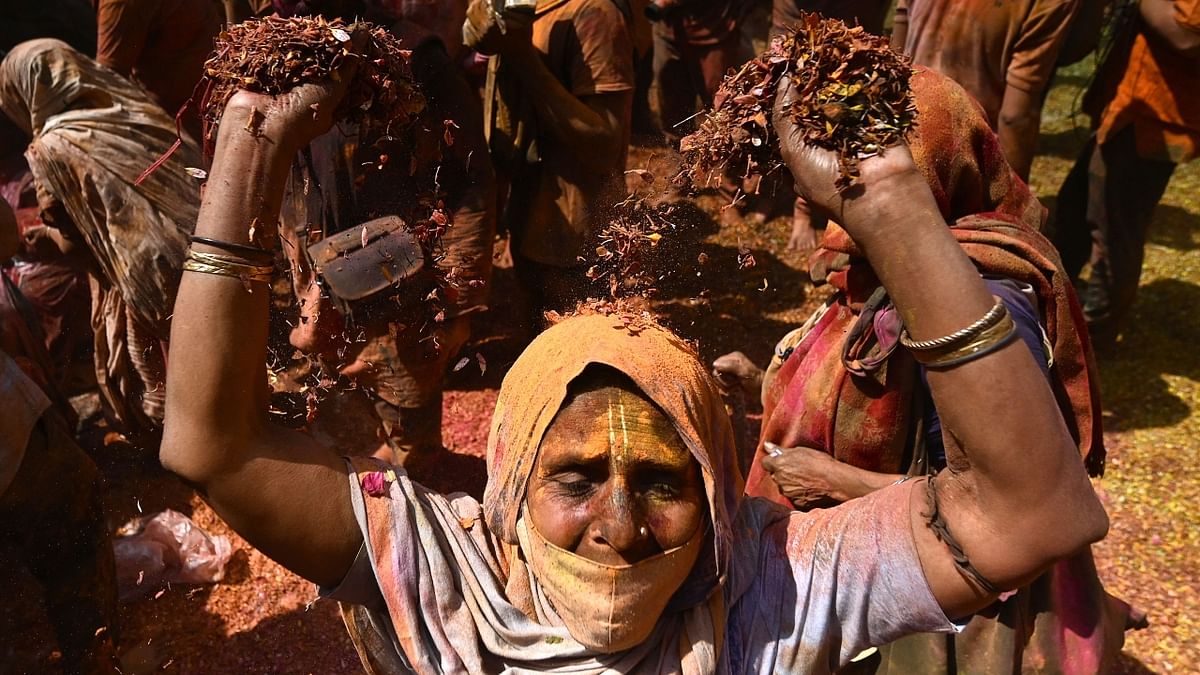 A widow is seen throwing flowers and colours during the Holi celebrations in Vrindavan. Credit: AFP Photo
