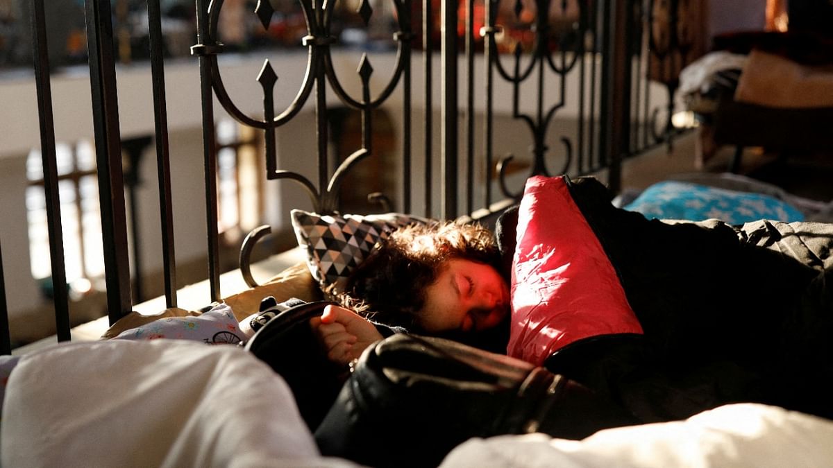 A person fleeing Russia's invasion of Ukraine rests at a reception point in an old train station in Krakow, Poland. Credit: Reuters Photo