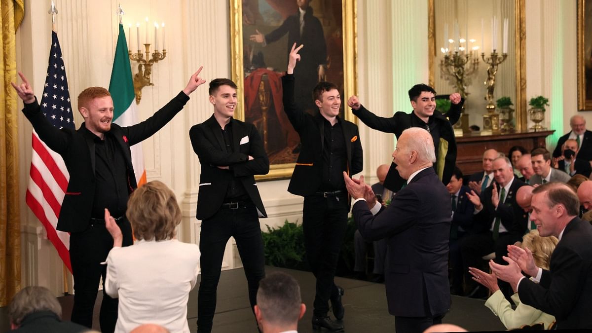 US President Joe Biden cheers for Cairde, an Irish dance group, after they performed on a stage for the president and first lady Jill Biden and other guests. Credit: Reuters Photo