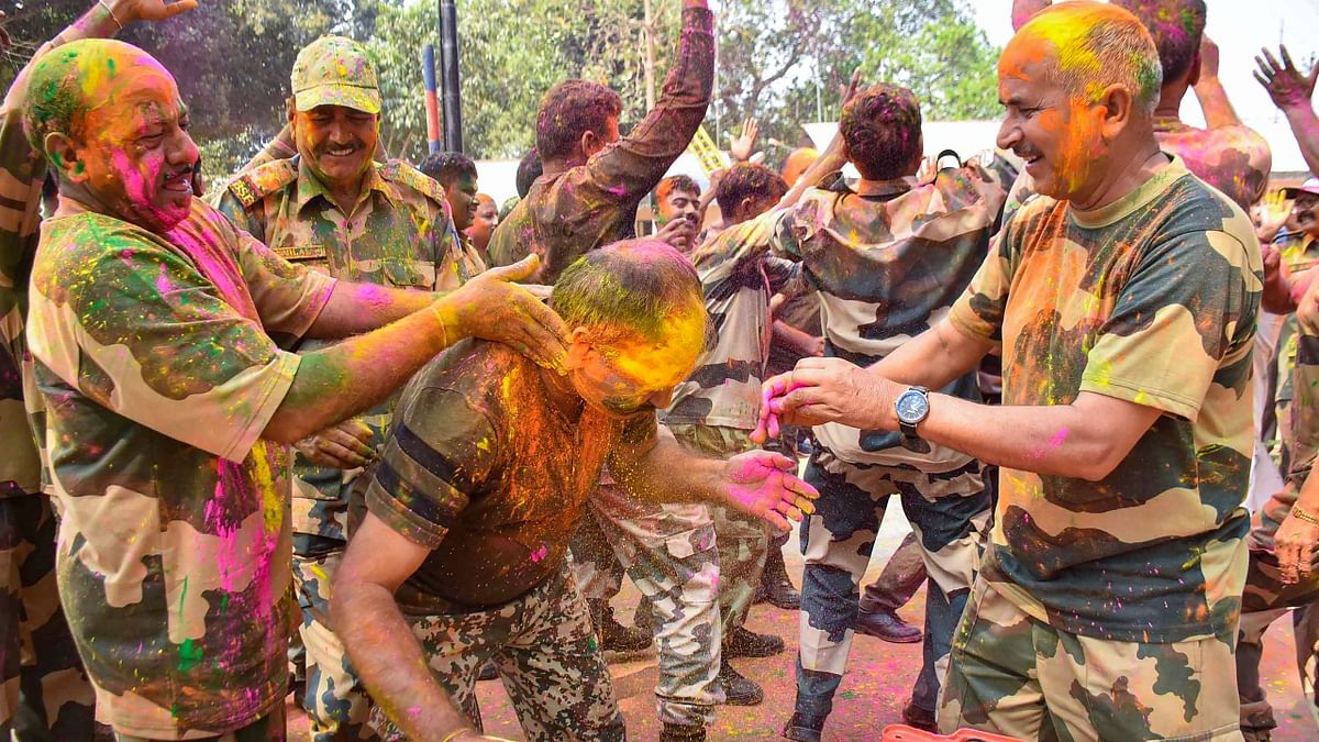 Border Security Force (BSF) and Border Guard of Bangladesh apply colours during the Holi festival, on the outskirts of Agartala. Credit: PTI Photo